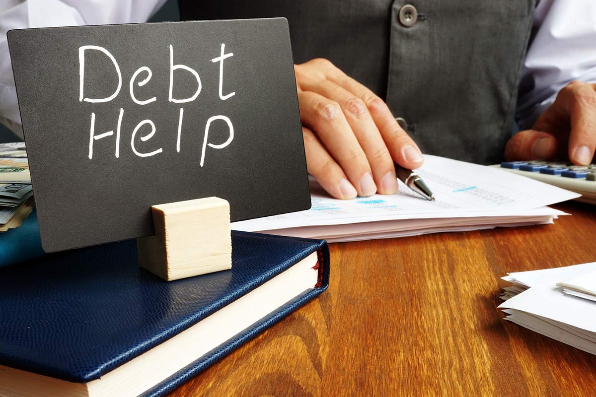 Debt help sign and working man in the office